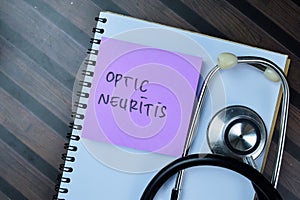 Concept of Optic Neuritis write on sticky notes with stethoscope isolated on Wooden Table