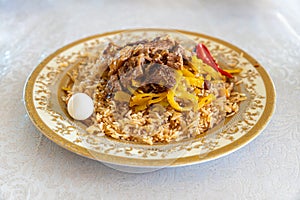 The concept of oriental cuisine. Homemade Uzbek pilaf or plov from lamb in plate. C