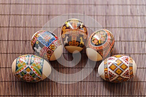 The concept of Orthodox Easter, religious holidays in Ukraine. Close-up of five easter eggs on a brown mat.