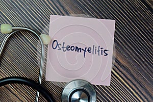 Concept of Osteomyelitis write on sticky notes isolated on Wooden Table