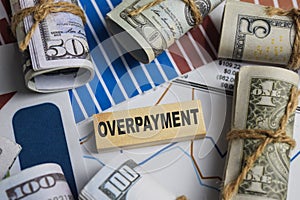 Concept of Overpayment. Wooden block with words overpayment