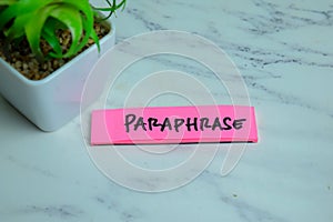 Concept of Paraphrase write on sticky notes isolated on Wooden Table