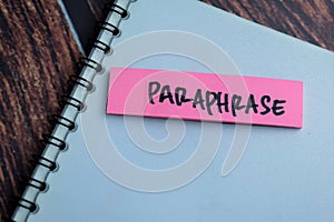 Concept of Paraphrase write on sticky notes isolated on Wooden Table photo