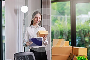 Concept of parcel delivery and selling online,Retailer writing customer detail on parcel box and prepare to send product parcel to
