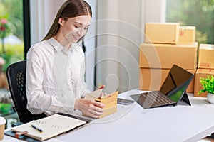 Concept of parcel delivery and selling online,Retailer writing customer detail on parcel box and prepare to send product parcel to
