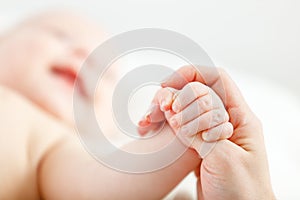 Concept of parental love. baby hand holding finger of mother