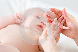 Concept of parental love. baby hand holding finger of mother