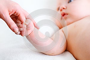 Concept of parental love. baby hand holding finger of mother