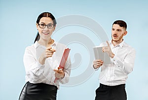 Concept of partnership in business. Young man and woman standing at studio