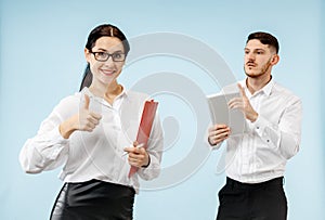 Concept of partnership in business. Young man and woman standing at studio