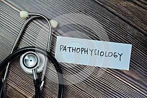 Concept of Pathophysiology write on sticky notes with sthethoscope isolated on Wooden Table photo