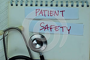 Concept of Patient Safety write on sticky notes isolated on Wooden Table