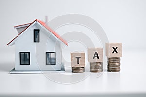 Concept of paying state property tax. Property Tax Wooden Blocks With A Miniature House. house model, mortgage loading real estate