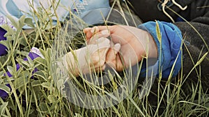 The concept of peace and happiness. Slow motion hand of a man and a woman in medieval costumes lie in the grass