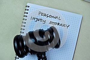 Concept of Personal Injury Attorney write on book with gavel isolated on Wooden Table