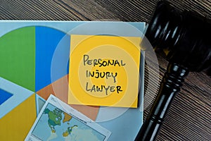 Concept of Personal Injury Lawyer write on sticky notes isolated on Wooden Table