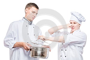 Concept photo - cooks and foul soup in a pan, shooting