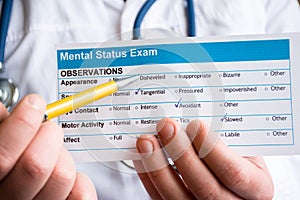 Concept photo psychiatric examination, assessment or consultation. Psychiatrist holds conclusion mental status exam and handle on