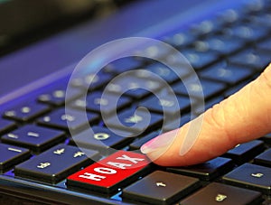 Finger pressing pushing down red hoax scam computer keyboard button word photo