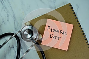 Concept of Pilonidal Cyst write on sticky notes with stethoscope isolated on Wooden Table