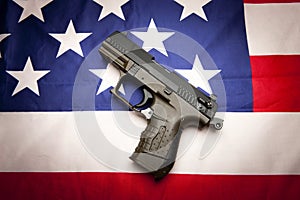 Concept of pistol on the flag. photo