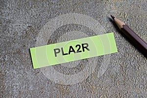 Concept of PLA2R - Phospholipase A2 Receptor write on sticky notes isolated on Wooden Table