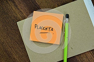 Concept of Placenta write on sticky notes isolated on Wooden Table