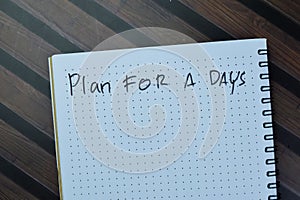 Concept of Plan For a Days write on book isolated on Wooden Table