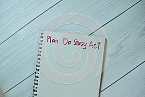 Concept of Plan Do Study Act write on book isolated on Wooden Table