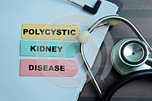 Concept of Polycystic Kidney Disease write on sticky notes with stethoscope isolated on Wooden Table