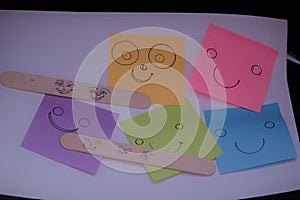 Concept a positive attitude with small office sticky notes with multiple faces.