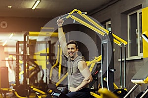 Muscular man working out in gym doing exercises