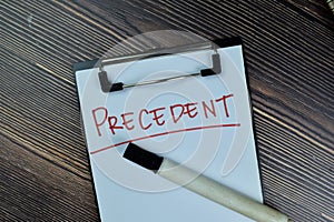 Concept of Precedent write on a paperwork isolated on Wooden Table