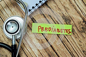 Concept of Prediabetes write on sticky notes with stethoscope isolated on Wooden Table