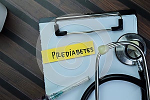 Concept of Prediabetes write on sticky notes with stethoscope isolated on Wooden Table