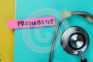 Concept of Prediabetes write on sticky notes with stethoscope isolated on Wooden Table