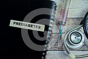 Concept of Prediabetes write on sticky notes with stethoscope isolated on Wooden Table