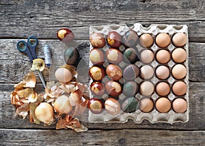 The concept of preparing for the Easter holiday. Painted eggs on a wooden background