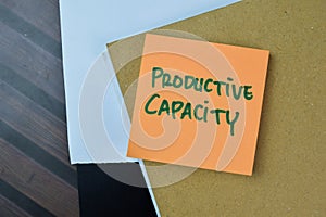 Concept of Productive Capacity write on sticky notes isolated on Wooden Table
