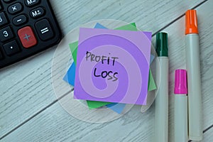 Concept of Profit Loss write on sticky notes isolated on Wooden Table