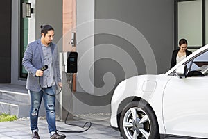 Concept of progressive couple with home charging station for electric vehicle.