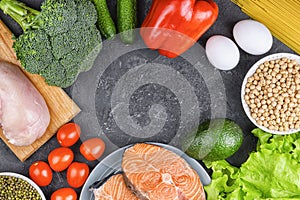 The concept of proper nutrition, diet. Vegetables, cereals, fish, eggs and chicken on a black background, flat lay. Copy