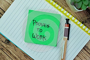 Concept of Proven To Work write on sticky notes isolated on Wooden Table