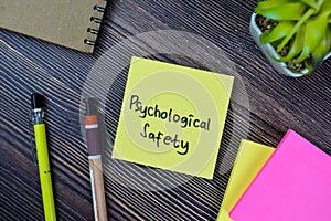 Concept of Psychological Safety write on sticky notes isolated on Wooden Table