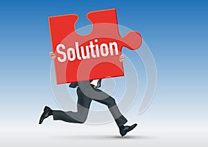 Concept of the problem with a man who brings a puzzle piece on which is written the word solution. photo