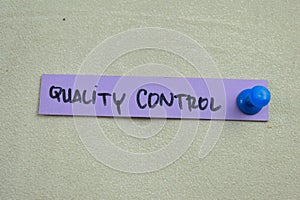 Concept of Quality Control write on sticky notes isolated on Wooden Table