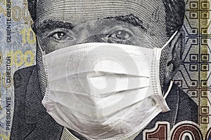 Concept: Quarantine in Peru, 100 Soles banknote with face mask. Economy and financial markets affected by corona virus photo