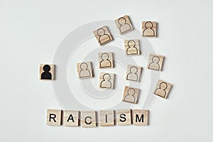 Concept of racism and misunderstanding between people, prejudice and discrimination. Wooden block with a white black figure