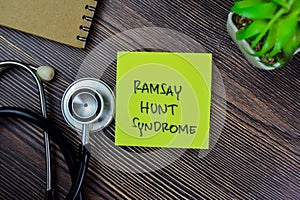 Concept of Ramsay Hunt Syndrome write on sticky notes with stethoscope isolated on Wooden Table photo