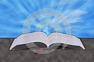 Concept of rays from heaven shining down on a Christian bible